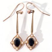 Pair of 9ct gold sapphire and seed pearl open work pendant earrings, each centring an oval faceted