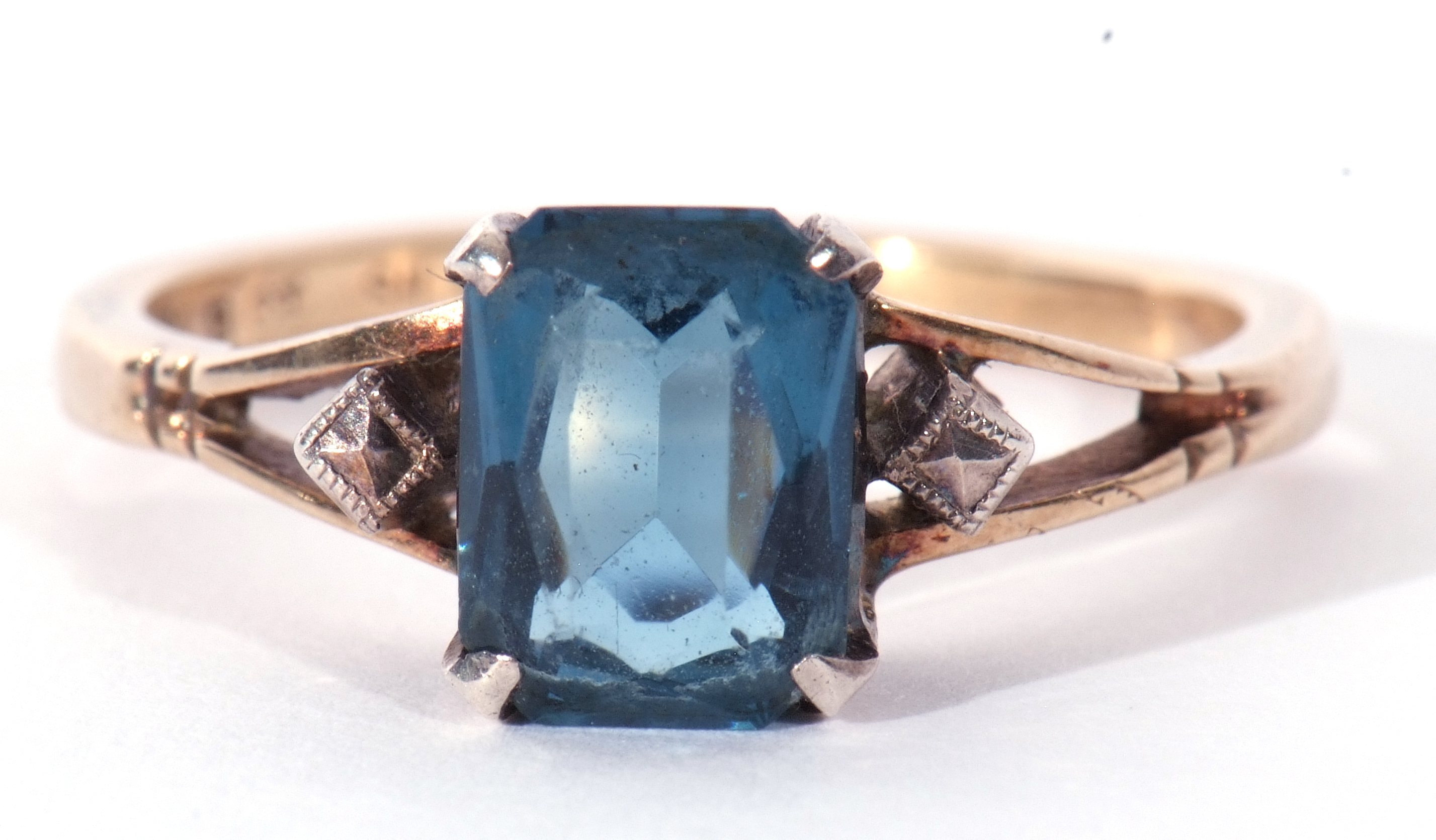 Modern blue stone ring set between two marcasite set shoulders, stamped 9ct and silver, size N