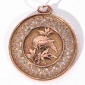 Yellow metal Chinese pendant of pierced round design, one side centrally decorated with a dragon,