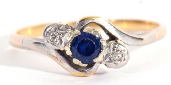 Sapphire and diamond cross over ring, the round shape faceted sapphire between two small single