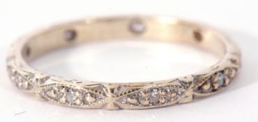 Precious metal and diamond set eternity ring featuring ten small diamonds in engraved beaded