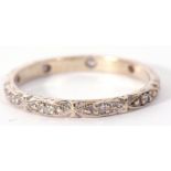 Precious metal and diamond set eternity ring featuring ten small diamonds in engraved beaded