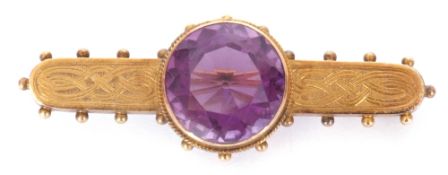 Antique Etruscan amethyst brooch centring a round faceted amethyst, 14mm diam, in a cut down