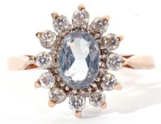 9ct gold and paste set cluster ring, the light blue coloured centre stone surrounded by 12 small
