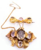 Victorian gold foil and ribbon design brooch with drop in rococo taste, set with semi-precious gem