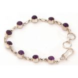 White metal and amethyst bracelet featuring nine cabochon amethysts, each individually set in cut
