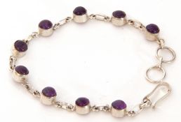 White metal and amethyst bracelet featuring nine cabochon amethysts, each individually set in cut