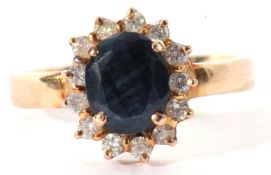 Sapphire and small diamond cluster ring, the oval shaped sapphire 8 x 6mm, raised above a small