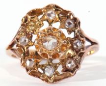 Unmarked yellow metal ring, featuring 9 rose cut diamonds, (one replacement paste stone), each