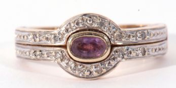 9ct gold amethyst and diamond cluster ring centring an oval shaped amethyst in rub over setting