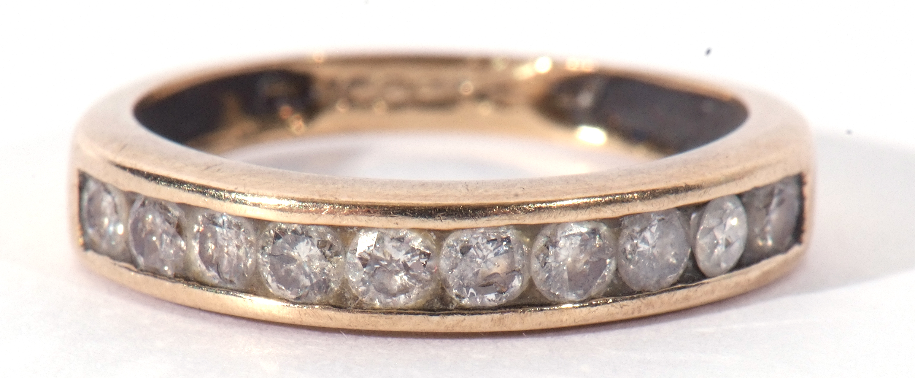 Diamond half hoop ring featuring ten small channel set round brilliant cut diamonds, size J (