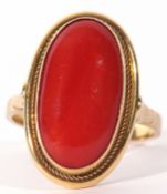750 stamped carnelian dress ring, the oval cabochon carnelian 18 x 8mm, framed in a cut down setting