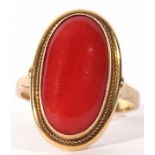 750 stamped carnelian dress ring, the oval cabochon carnelian 18 x 8mm, framed in a cut down setting