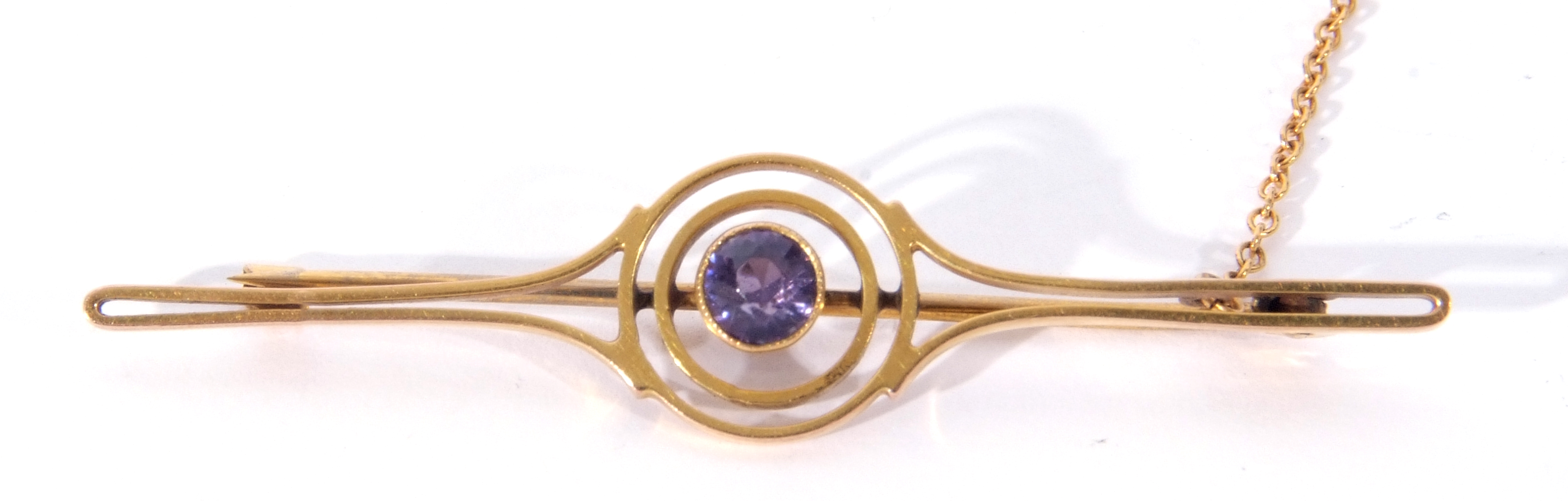 9ct stamped open work brooch centring a round brilliant cut amethyst, 6cm long, g/w 3.2gms