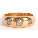 Antique three-stone diamond ring featuring three old cut diamonds, each in engraved square settings,