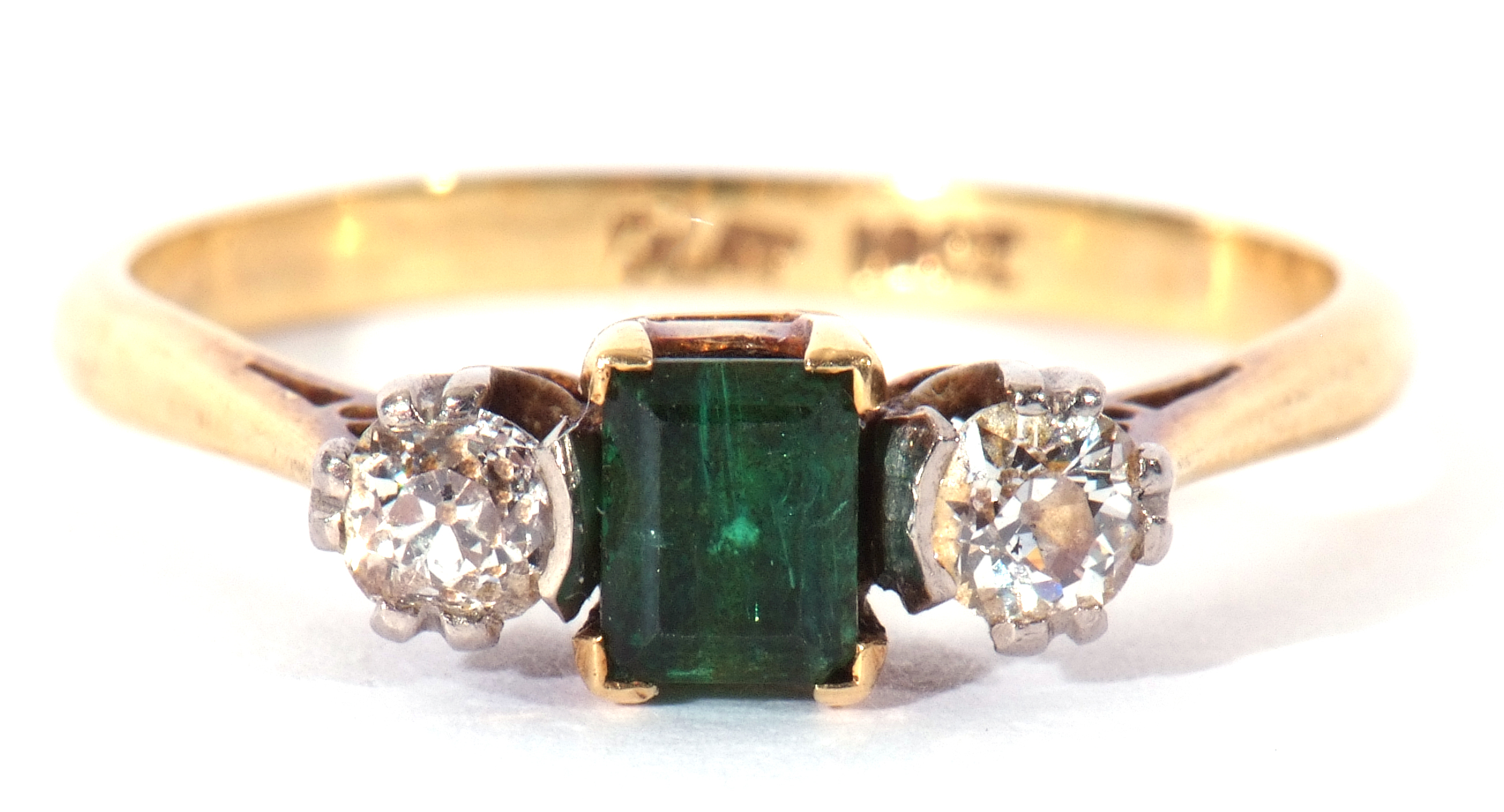 Emerald and diamond three stone ring, the step cut emerald 4.3mm x 3mm, flanked by two round