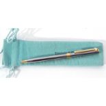 Tiffany & Co stainless steel ballpoint pen with gilt metal T-shaped clip and mounts, engraved '