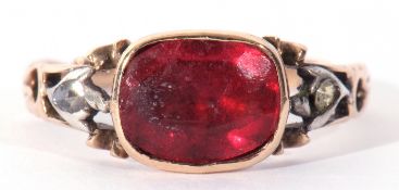 Antique paste set ring, the foil backed red stone framed in an engraved enclosed setting between