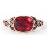 Antique paste set ring, the foil backed red stone framed in an engraved enclosed setting between