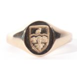 9ct gold shield shaped signet ring, the oval panel chased and engraved with a shield raised