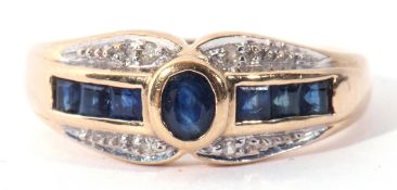 A modern sapphire and diamond ring, centring an oval bezel-set sapphire