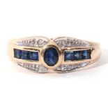 A modern sapphire and diamond ring, centring an oval bezel-set sapphire