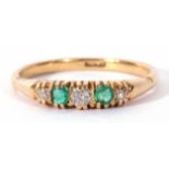 Antique diamond and emerald ring featuring three graduated old cut diamonds and two cushion cut