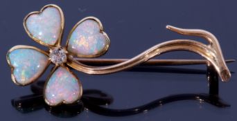 An opal and diamond brooch, a flower design with four heart shaped opal petals highlighted with a