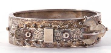 Antique silver hinged bangle, the top section chased and engraved and applied with a belt and buckle
