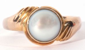 Yellow metal and cultured grey pearl ring, the pearl 8mm diam, bezel set between engraved cross over