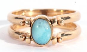 Modern reversible ring featuring opposite blue and amber coloured stones, bezel set between hinged