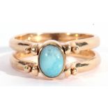 Modern reversible ring featuring opposite blue and amber coloured stones, bezel set between hinged