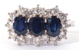 Precious metal, sapphire and diamond cluster ring, having three oval shaped sapphires within a