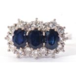 Precious metal, sapphire and diamond cluster ring, having three oval shaped sapphires within a