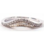 Modern precious metal diamond wishbone ring set with baguette and single stone diamonds, stamped