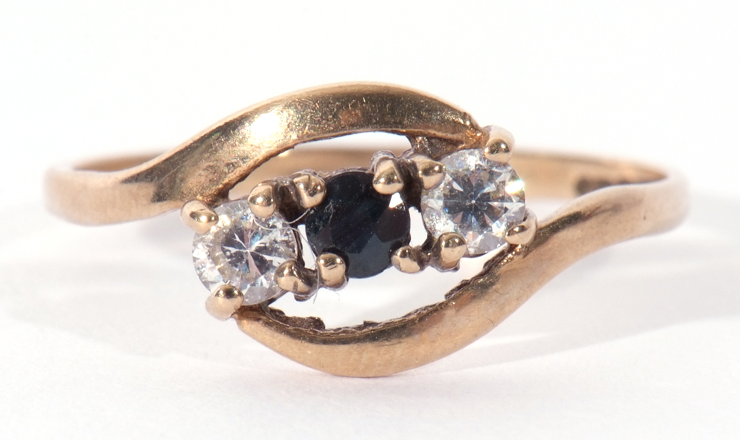 Modern 9ct gold diamond and sapphire cross over ring featuring a round cut sapphire between two