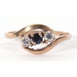 Modern 9ct gold diamond and sapphire cross over ring featuring a round cut sapphire between two