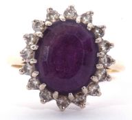 18ct gold, amethyst and diamond cluster ring, the large central oval faceted amethyst 12 x 10mm,