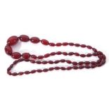 Cherry amber bead necklace, a single row of graduated oval beads, 26/10mm to a bead screw clasp, g/w