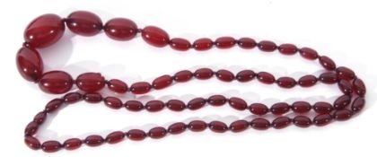 Cherry amber bead necklace, a single row of graduated oval beads, 26/10mm to a bead screw clasp, g/w
