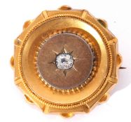Victorian gilt metal and paste set target brooch with a glazed hair panel verso, 3cm diam