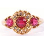 18ct gold red and pink three stone ring, highlighted with five small diamonds (five missing), 3.5gms