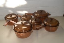 FIVE GLASS SAUCEPANS