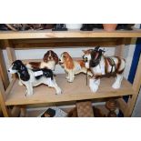 THREE POTTERY SPANIELS AND A POTTERY CARTHORSE (4)