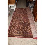 MODERN FLOOR RUG DECORATED WITH FLORAL PATTERN ON RED BACKGROUND, 235CM WIDE