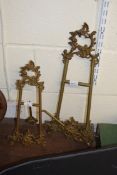 TWO BRASS TABLE EASELS WITH FOLIATE DECORATION