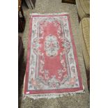 SMALL CHINESE WOOL FLOOR RUG DECORATED WITH ROSES ON A PINK AND BEIGE BACKGROUND, 153CM LONG