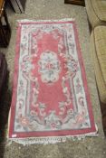 SMALL CHINESE WOOL FLOOR RUG DECORATED WITH ROSES ON A PINK AND BEIGE BACKGROUND, 153CM LONG