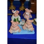 FOUR NATWEST PIGGY BANKS PLUS A PIGGY BANK STATEMENT HOLDER (5)