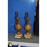 PAIR OF BRONZED METAL EWERS SET ON POLISHED ONYX STANDS
